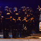 A protester stands with arms raised near a line of officers from the Charlotte-Mecklenburg Police Department in riot gear Sept. 20, 2016, in Charlotte, N.C.
Jeff Siner/Charlotte Observer/TNS via Getty Images